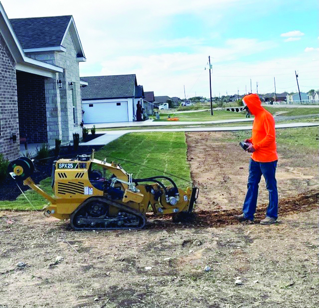 A crew installs a fiber drop and tracer wire with a stitching machine during an installation. United recommends that members should call 811 to locate all buried utilities before doing any digging this spring.
